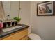 Bathroom vanity with dark countertop, framed Gathering photo on wall, and modern faucet fixture at 270 Alcovy Reserve Way, Covington, GA 30014