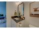 Bathroom features a vanity with granite top, framed mirror, and view into the adjacent bedroom at 270 Alcovy Reserve Way, Covington, GA 30014