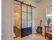 Bathroom featuring a glass shower door with dark metal trim and light hardwood floors at 270 Alcovy Reserve Way, Covington, GA 30014
