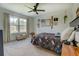 Bedroom featuring a ceiling fan, large window, and carpeted floor at 270 Alcovy Reserve Way, Covington, GA 30014