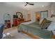 Bright bedroom featuring a wooden bed frame, ceiling fan, and dresser with decorative mirror at 270 Alcovy Reserve Way, Covington, GA 30014