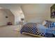 Well-lit bedroom showcasing carpet floors, a patterned bedspread, and angled ceilings at 270 Alcovy Reserve Way, Covington, GA 30014