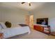 Cozy bedroom setup featuring a ceiling fan, TV, and an attached bathroom for added convenience at 270 Alcovy Reserve Way, Covington, GA 30014