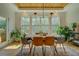 Sunlit dining room with modern table, chairs, and large windows overlooking the yard at 270 Alcovy Reserve Way, Covington, GA 30014