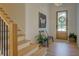 Staircase in the entryway of a modern home with hardwood floors and bright light at 270 Alcovy Reserve Way, Covington, GA 30014