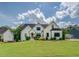 Beautiful home featuring white exterior, dark trim, well-kept lawn, and a manicured landscape at 270 Alcovy Reserve Way, Covington, GA 30014