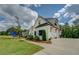 Bright exterior showcasing lush landscaping, a curved walkway, and a three-car garage at 270 Alcovy Reserve Way, Covington, GA 30014