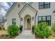 Charming front entrance with an arched doorway, brick facade, and landscaped greenery at 270 Alcovy Reserve Way, Covington, GA 30014