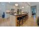 Modern kitchen features a large island with seating, white cabinetry, and hardwood floors at 270 Alcovy Reserve Way, Covington, GA 30014