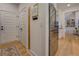 Open kitchen area with stainless steel refrigerator, wood flooring, and seamless flow into the living space at 270 Alcovy Reserve Way, Covington, GA 30014