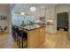 Bright kitchen featuring a large island with seating, modern appliances, and hardwood floors at 270 Alcovy Reserve Way, Covington, GA 30014