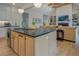 Kitchen island and stainless steel appliances with open floor plan view to the living room at 270 Alcovy Reserve Way, Covington, GA 30014