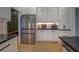 Modern kitchen features stainless steel appliances, white cabinets, black countertops, and wood-look flooring at 270 Alcovy Reserve Way, Covington, GA 30014