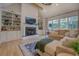 Bright living room featuring a fireplace, built-in bookshelves, and natural light at 270 Alcovy Reserve Way, Covington, GA 30014