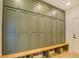 Mudroom boasts built-in storage with bench seating and green cabinetry with brushed gold hardware at 270 Alcovy Reserve Way, Covington, GA 30014
