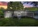 Backyard at sunset showcasing the wooden deck with screened-in porch at 3337 Toney Dr, Decatur, GA 30032