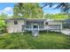 Well-maintained backyard showcasing a wooden deck with screened-in porch and lovely landscaping at 3337 Toney Dr, Decatur, GA 30032