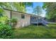 A lush green backyard featuring a wooden deck with a screened-in porch at 3337 Toney Dr, Decatur, GA 30032