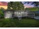 Charming home featuring a spacious backyard with a wooden deck and screened in porch, captured at sunset at 3337 Toney Dr, Decatur, GA 30032
