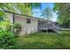 Spacious backyard featuring a deck and screened-in porch, surrounded by mature trees and greenery at 3337 Toney Dr, Decatur, GA 30032