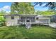 Charming home featuring a spacious backyard with a wooden deck and screened in porch, perfect for outdoor entertaining at 3337 Toney Dr, Decatur, GA 30032
