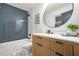 Modern bathroom with blue tiled shower and stylish wooden vanity at 3337 Toney Dr, Decatur, GA 30032