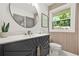 Beautiful bathroom features a large mirror, modern vanity, and a window at 3337 Toney Dr, Decatur, GA 30032
