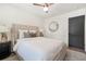 Bedroom with a gray door, neutral decor, and a large round mirror at 3337 Toney Dr, Decatur, GA 30032