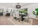 Bright dining area with modern lighting, seating for six, and a sliding door to the backyard at 3337 Toney Dr, Decatur, GA 30032