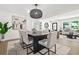 Contemporary dining area with modern lighting, seating for six, and open access to the living room at 3337 Toney Dr, Decatur, GA 30032