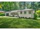 Charming painted brick ranch-style home featuring a well-manicured lawn and mature trees at 3337 Toney Dr, Decatur, GA 30032