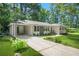 Inviting brick home featuring a carport, updated windows, and a lush green lawn at 3337 Toney Dr, Decatur, GA 30032