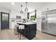 Updated kitchen with an island, breakfast bar seating, stainless steel appliances, and modern finishes at 3337 Toney Dr, Decatur, GA 30032