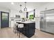Eat-in kitchen featuring white cabinets, a tile backsplash, an island with seating, and stainless appliances at 3337 Toney Dr, Decatur, GA 30032