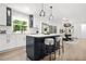 Modern kitchen with an island, pendant lighting, stainless steel appliances, and sleek white cabinetry at 3337 Toney Dr, Decatur, GA 30032