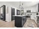 Bright kitchen featuring a large island, stainless steel appliances, and modern lighting fixtures at 3337 Toney Dr, Decatur, GA 30032