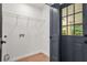 Functional laundry room with overhead shelving and an exterior door at 3337 Toney Dr, Decatur, GA 30032