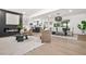 Bright open-concept living space with modern fireplace and decor that flows into the dining and kitchen areas at 3337 Toney Dr, Decatur, GA 30032
