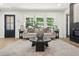 Cozy living area with large windows, a plush sofa, and a chic coffee table at 3337 Toney Dr, Decatur, GA 30032