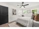 Bright main bedroom features a ceiling fan, two windows, and neutral decor at 3337 Toney Dr, Decatur, GA 30032