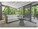 Inviting screened-in porch with comfortable seating and views of lush green trees at 3337 Toney Dr, Decatur, GA 30032