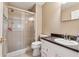 Clean bathroom with a glass-enclosed shower and single sink vanity at 461 Village Green Sw Ct, Lilburn, GA 30047