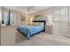 Comfortable bedroom with blue bedding, wall art, neutral-colored walls and carpeted floors at 461 Village Green Sw Ct, Lilburn, GA 30047
