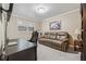 Cozy bedroom features a leather couch, desk, workstation, and artwork at 461 Village Green Sw Ct, Lilburn, GA 30047