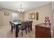 Comfortable dining room features a dark wood dining table, chandelier, mirror, six chairs and hardwood buffet at 461 Village Green Sw Ct, Lilburn, GA 30047