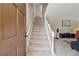 Entryway with carpeted stairs and view of living room area at 461 Village Green Sw Ct, Lilburn, GA 30047