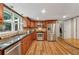 Well-lit kitchen with stainless steel appliances, granite countertops, and wood cabinets at 461 Village Green Sw Ct, Lilburn, GA 30047