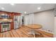 Well-lit kitchen with stainless steel appliances, wood cabinets, hardwood floors and eat-in breakfast table at 461 Village Green Sw Ct, Lilburn, GA 30047