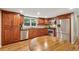Kitchen featuring wood cabinets, stainless steel appliances, and wood flooring at 461 Village Green Sw Ct, Lilburn, GA 30047