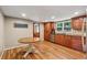 Eat-in kitchen featuring wood cabinets, stainless steel appliances, and wood flooring at 461 Village Green Sw Ct, Lilburn, GA 30047